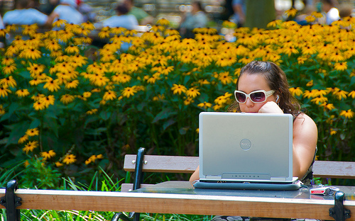 woman with laptop at park